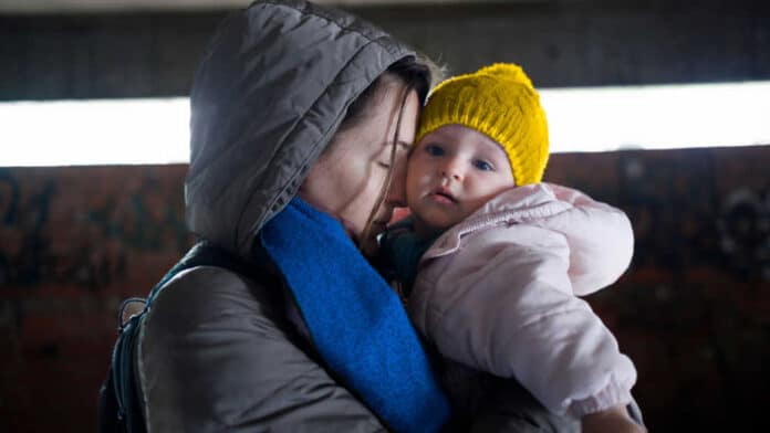 A woman hugging a child.