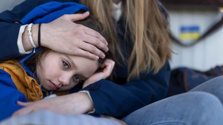 child nestled on someone